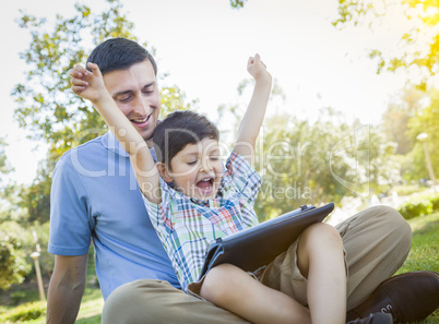 Handsome Mixed Race Father and Son Playing on Computer Tablet