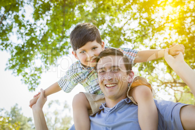 Father and Son Playing Piggyback in the Park