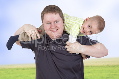 father carrying his child on his shoulders