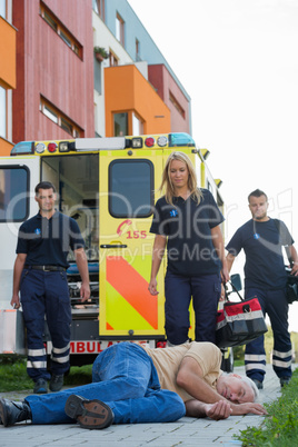 Paramedics coming to unconscious elderly man