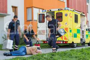 Paramedical team arriving to unconscious elderly man