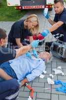 Paramedics examining unconscious man