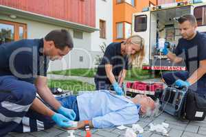 Paramedics giving firstaid to unconscious patient