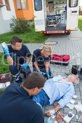 Paramedics treating injured man on street