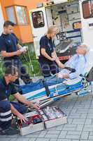 Paramedic team assisting injured man on stretcher
