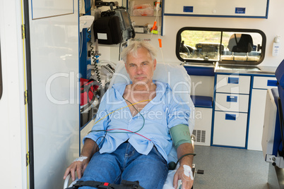 Injured man on stretcher in ambulance car