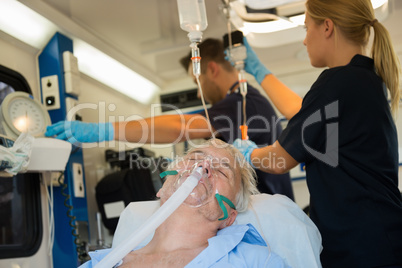 Unconscious patient with oxygen mask in ambulance