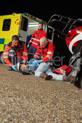 Emergency team helping injured motorbike driver