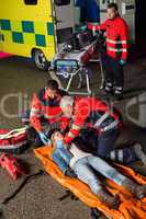 Emergency team helping injured motorcycle driver