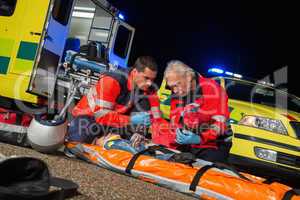 Paramedics giving firstaid to motorbike driver