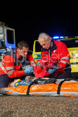 Paramedic team giving firstaid to injured woman