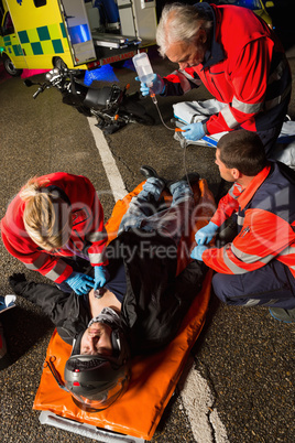 Paramedical team helping injured motorcycle driver