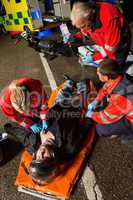 Paramedical team helping injured motorcycle driver
