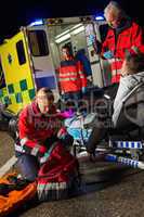 Paramedic team assisting injured motorbike driver