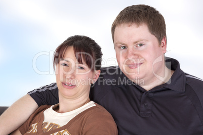 man and woman sitting together on the sofa