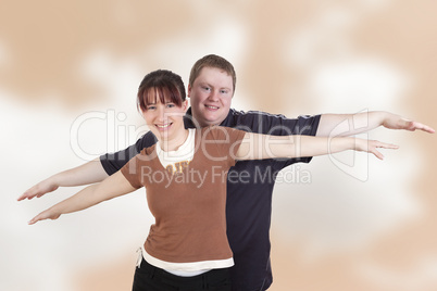 man and woman stretching her arms out with joy
