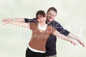 man and woman stretching her arms out with joy