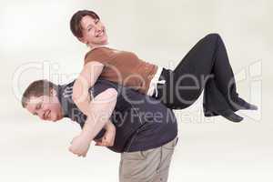man carrying woman on his back