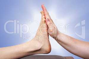 hand presses against foot