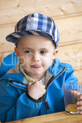 child sitting at the table with glass
