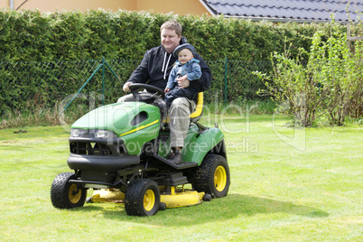 man and child in the garden tractor