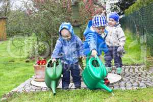 children with watering can in the garden