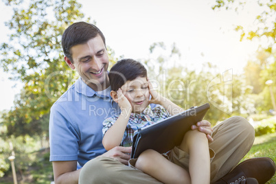 Handsome Mixed Race Father and Son Playing on Computer Tablet