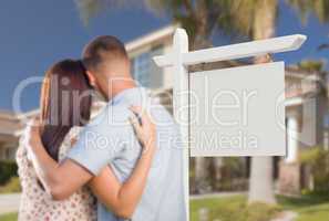 Blank Real Estate Sign and Military Couple Looking at House
