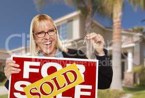 Excited Woman Holding House Keys and Sold Real Estate Sign