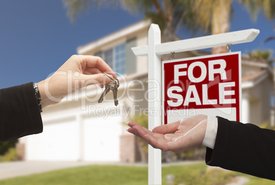 Agent Handing Over House Keys in Front of New Home