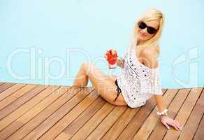 young blonde woman relaxing at the pool