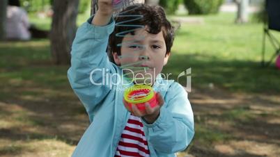 Child Playing With Colorful Plastic Spring Toy In Park
