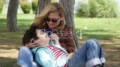 Mother and son relaxing time in park