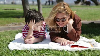 Mother  reading to son in the park