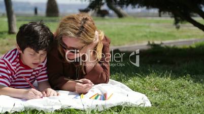 Mother and son painting in the park