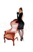 woman standing on armchair.