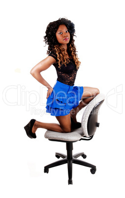 girl kneeling on chair.