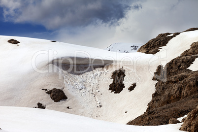 Snow cornice in spring mountains