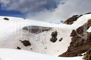 Snow cornice in spring mountains
