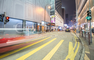 HONG KONG - APRIL 24, 2014: Red taxi cabs car light trails in Ko