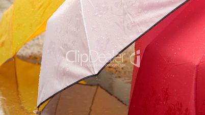 Rainy day and wet colorful umbrellas
