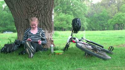 Girl using digital tablet computer in park
