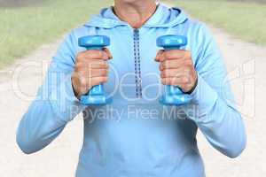 Woman with dumbbells during sport