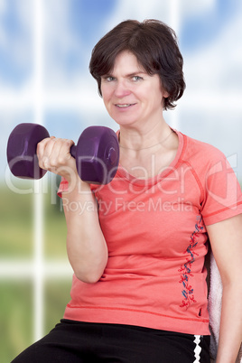 Woman with dumbbells during sport