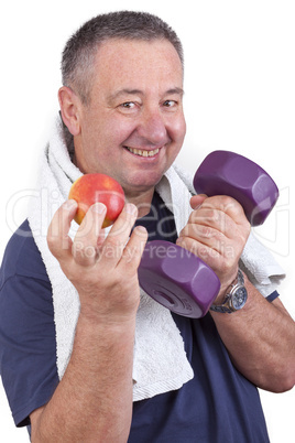 Elderly man with apple and dumbbells