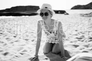 Pleased blonde woman in white beach dress
