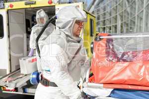 Biohazard medical team member with stretcher