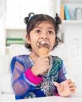 indian girl eating ice cream.