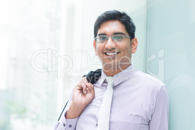 indian business man leaning on modern building