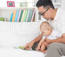 father and baby reading story book